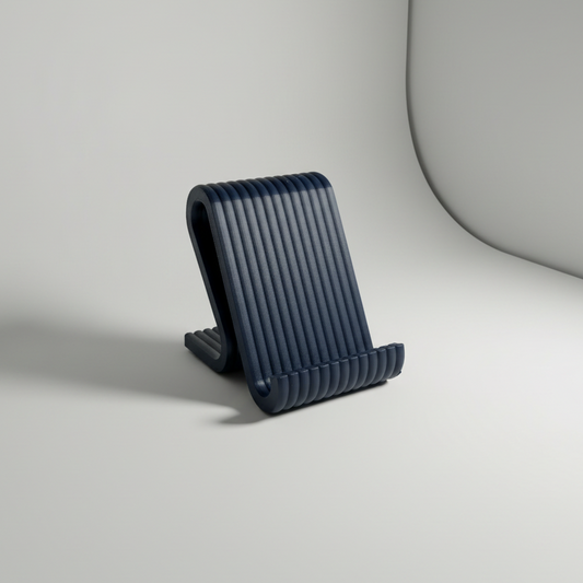A dark navy blue ribbed plastic phone stand on a light gray studio background.
