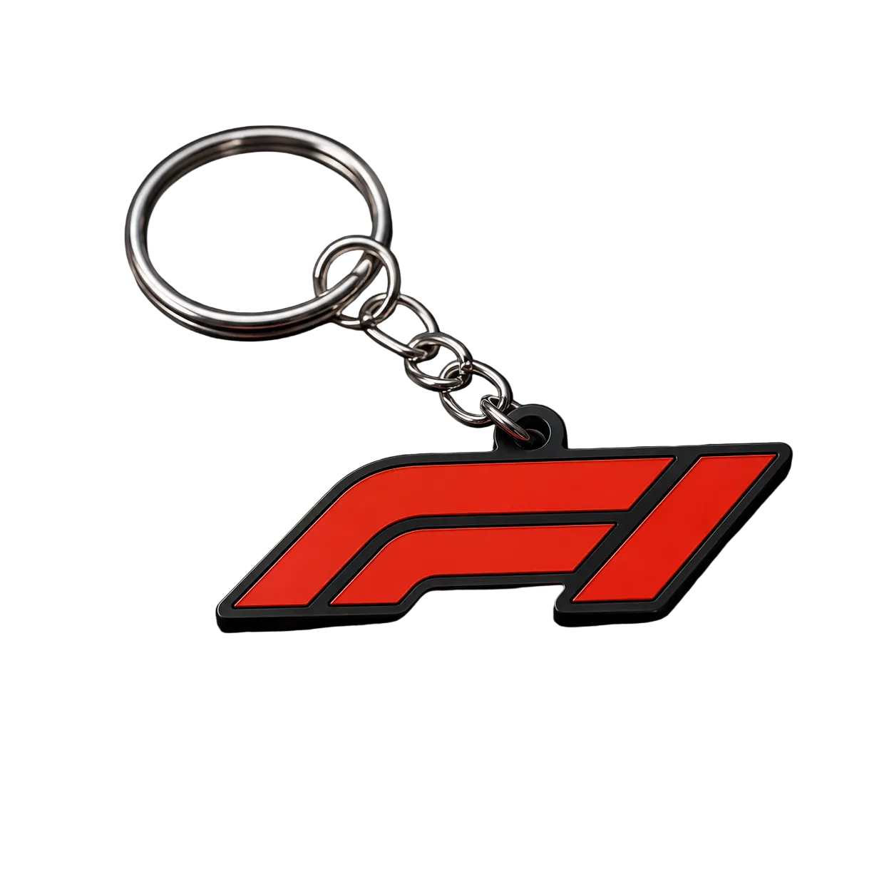 A red and black F1 logo keychain with a silver metal split ring and chain, displayed on a textured black carbon-fiber-style surface with a checkered pattern in the background.
