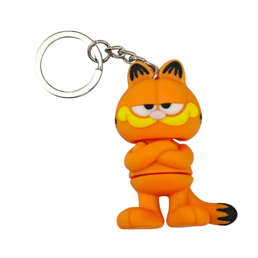 A Garfield keychain featuring a small orange cat figure with black stripes, yellow whiskers, and a silver metal key ring on a plain light background.