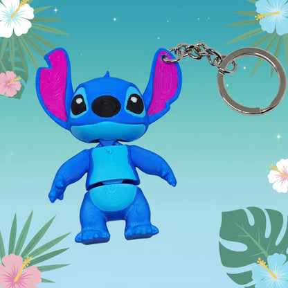 Blue cartoon character keychain with pink accents on a white background
